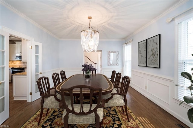 dining room with ornamental molding and dark hardwood / wood-style floors