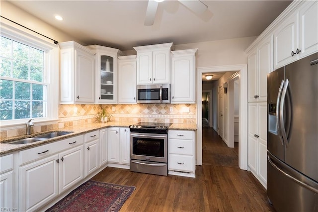 kitchen featuring light stone countertops, appliances with stainless steel finishes, sink, and white cabinets