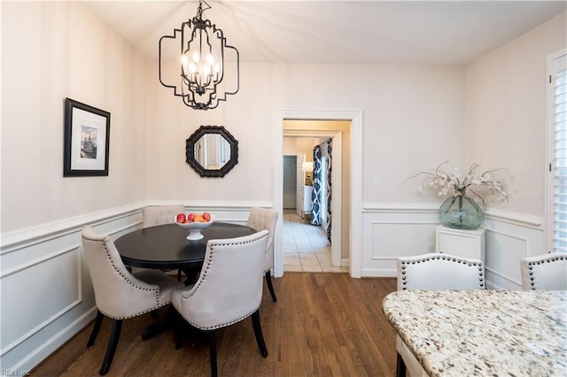 dining space featuring a notable chandelier and dark wood-type flooring