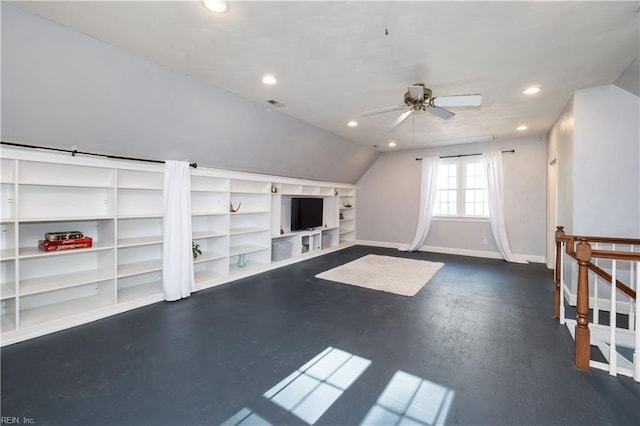 additional living space with built in shelves, vaulted ceiling, and ceiling fan