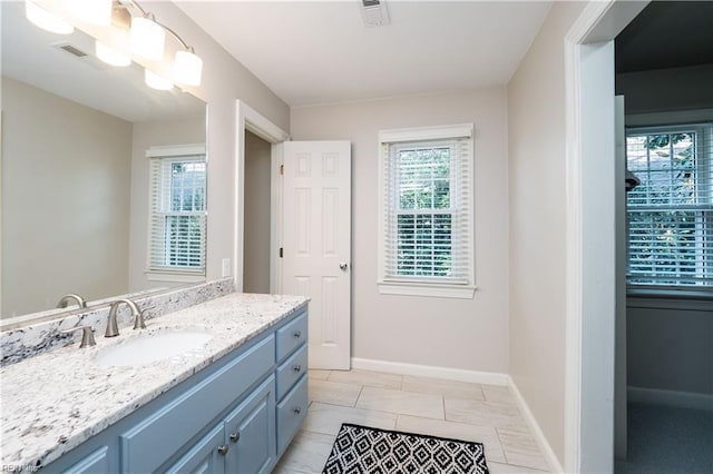 bathroom featuring vanity, tile patterned floors, and a healthy amount of sunlight