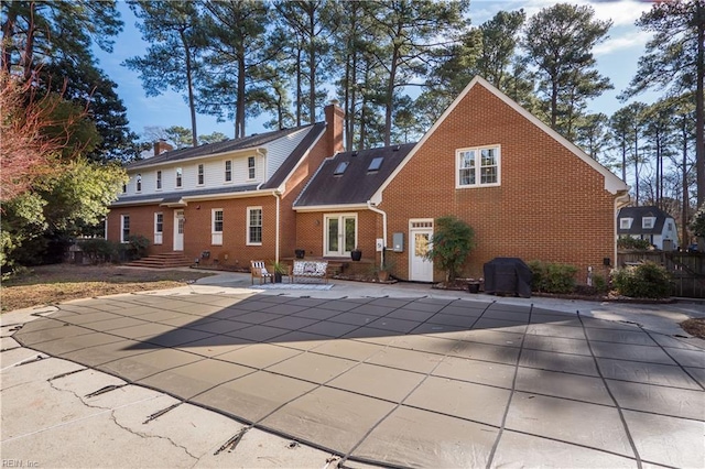 back of house with a patio area and a covered pool