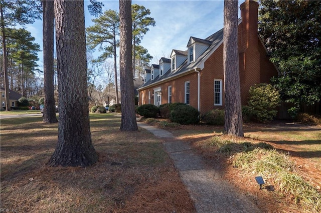 view of side of home featuring a lawn