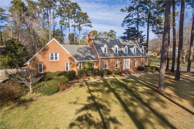 cape cod home with a front yard