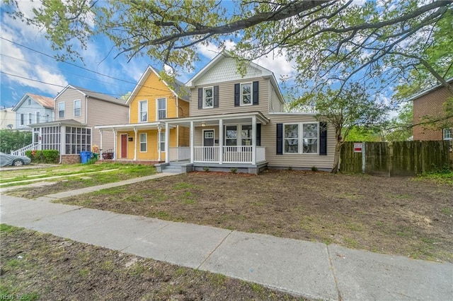 view of front of home featuring covered porch and a sunroom