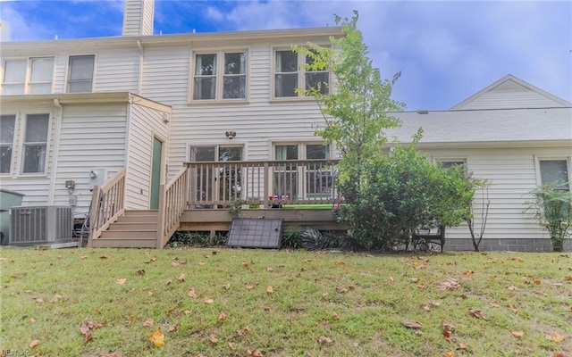 back of house with central AC unit, a yard, and a wooden deck