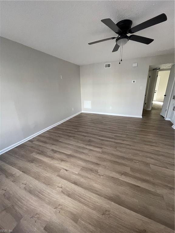 spare room with ceiling fan, dark hardwood / wood-style flooring, and a textured ceiling