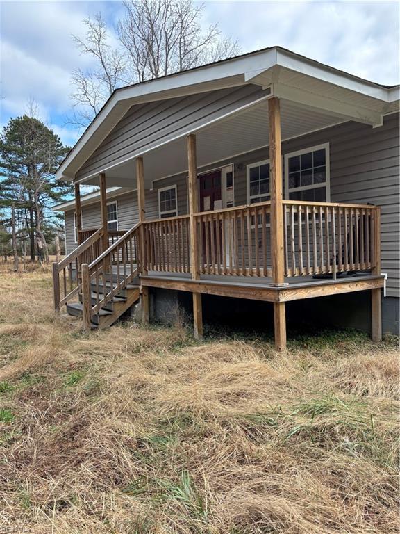 back of house with a wooden deck