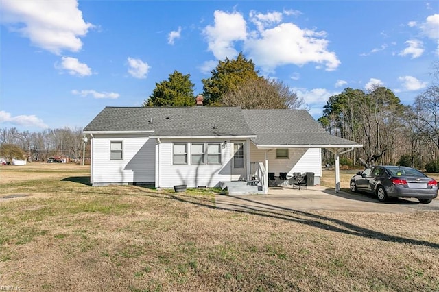 rear view of property featuring a lawn