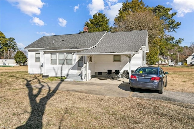 back of house featuring a patio area and a lawn