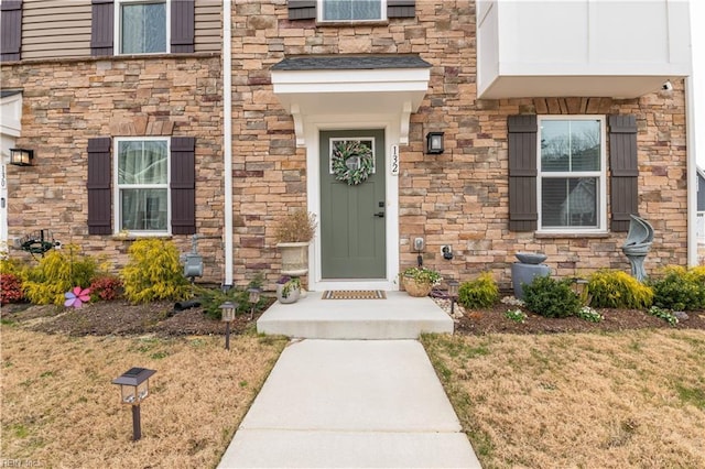 view of exterior entry featuring a yard