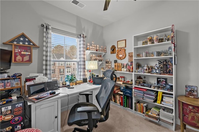 carpeted office space with ceiling fan