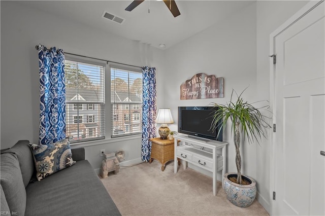 carpeted living room with ceiling fan