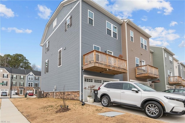 view of property exterior featuring a garage and central AC