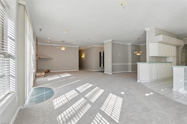 unfurnished living room with light carpet, crown molding, and ceiling fan with notable chandelier