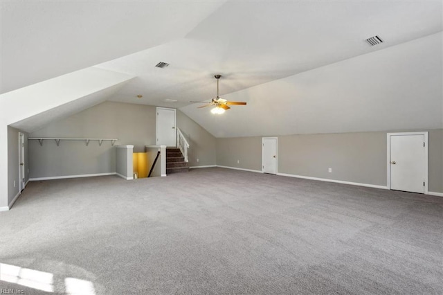 additional living space with ceiling fan, carpet floors, and vaulted ceiling