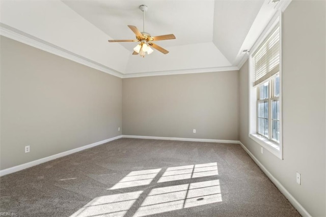 carpeted spare room with ceiling fan, crown molding, lofted ceiling, and a raised ceiling