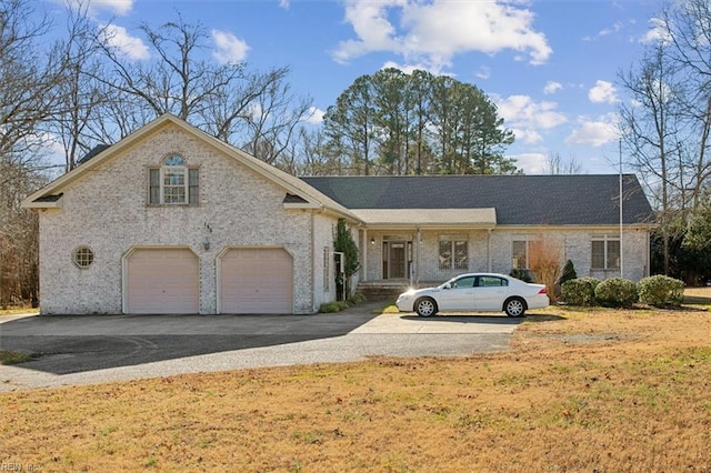 view of front of property with a garage and a front yard