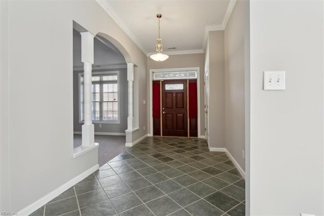 tiled foyer entrance with crown molding and decorative columns