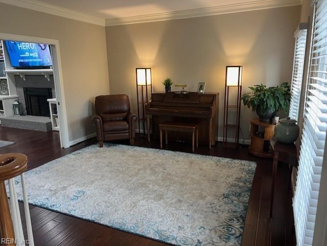 sitting room featuring dark hardwood / wood-style flooring and crown molding