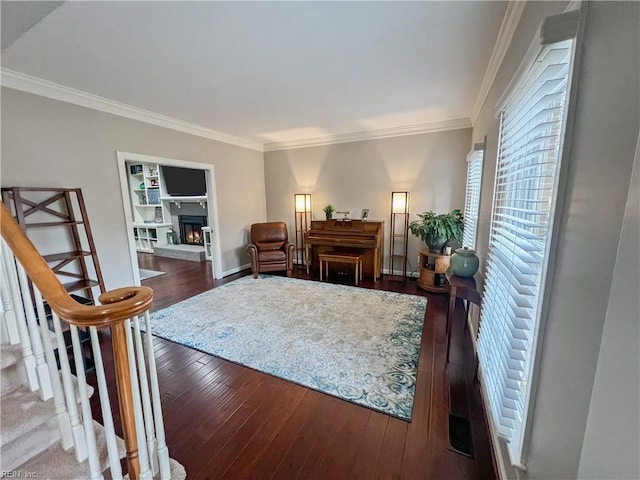 living room featuring dark wood-type flooring and ornamental molding