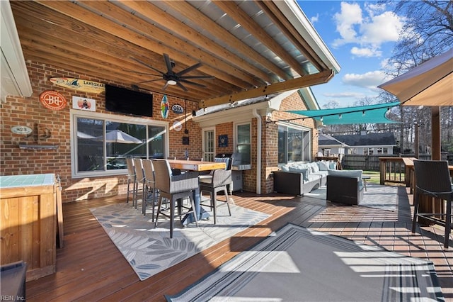 wooden deck featuring ceiling fan and an outdoor hangout area