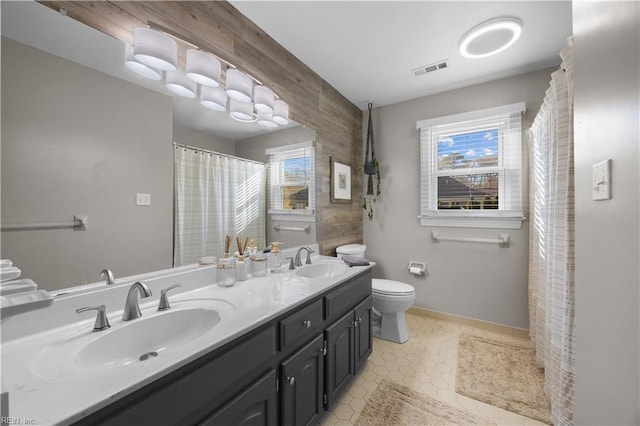 bathroom featuring vanity, tile patterned floors, and toilet