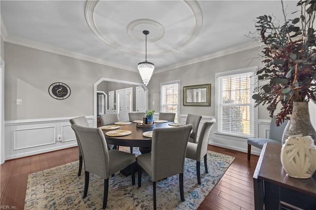 dining space with ornamental molding, dark hardwood / wood-style floors, and an inviting chandelier