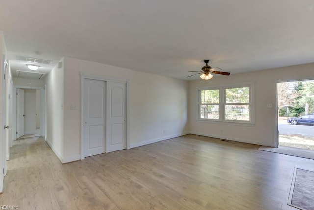 spare room featuring ceiling fan and light hardwood / wood-style flooring