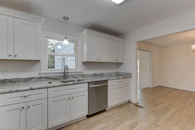 kitchen featuring light wood-type flooring, light stone countertops, stainless steel dishwasher, white cabinets, and sink