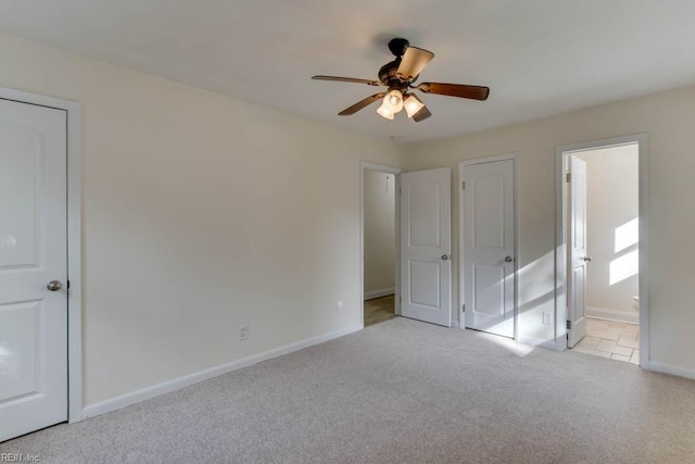 unfurnished bedroom with light carpet, ceiling fan, and ensuite bathroom