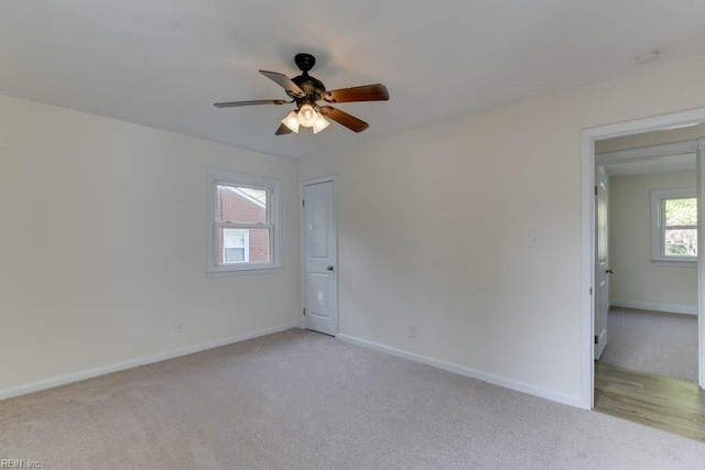 unfurnished room featuring ceiling fan and light colored carpet