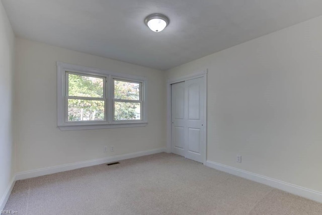 spare room with light colored carpet