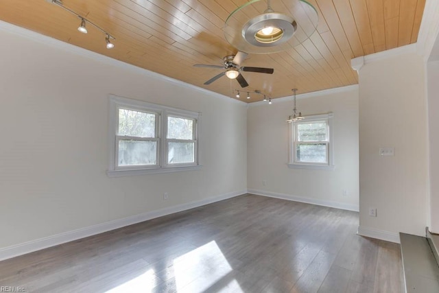 empty room with ceiling fan, wood ceiling, ornamental molding, and hardwood / wood-style floors