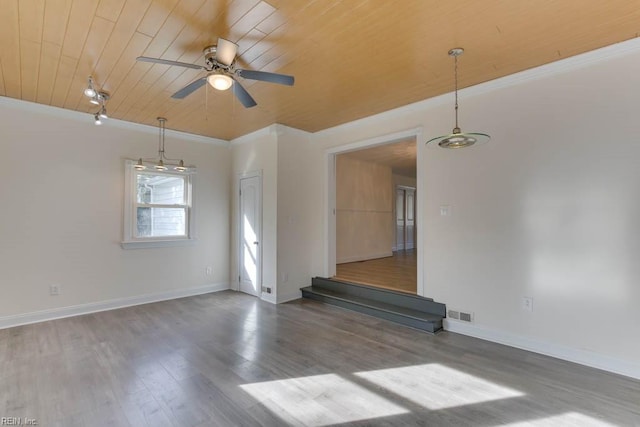 spare room with ceiling fan, dark hardwood / wood-style floors, crown molding, and wooden ceiling