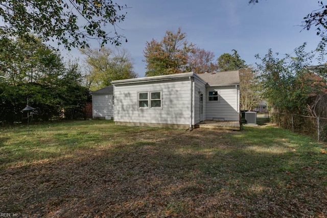 view of outdoor structure with central AC unit and a yard