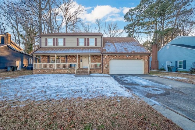 view of front of home with covered porch, a garage, and central air condition unit