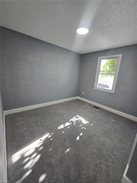 empty room featuring a textured ceiling