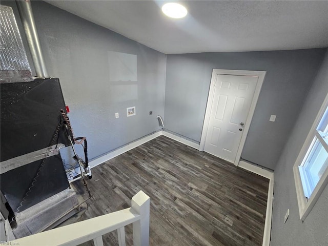 clothes washing area with dark hardwood / wood-style flooring