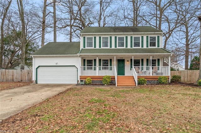 colonial home with a garage, a front lawn, and a porch