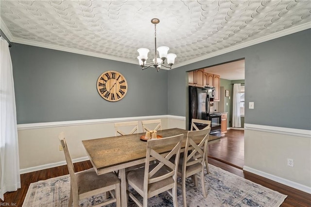 dining room with ornamental molding, a chandelier, and dark hardwood / wood-style flooring