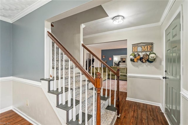 stairway with hardwood / wood-style flooring and crown molding