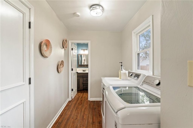 washroom with dark hardwood / wood-style floors and washing machine and clothes dryer