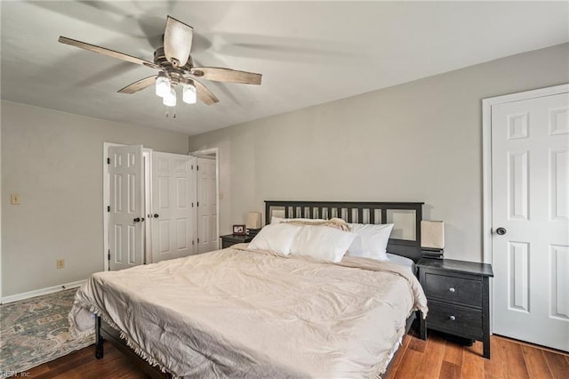 bedroom with ceiling fan and dark hardwood / wood-style floors