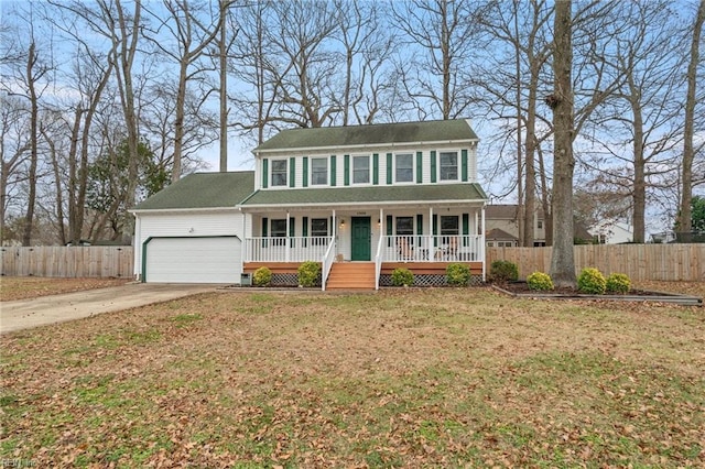 colonial-style house with covered porch, a front lawn, and a garage