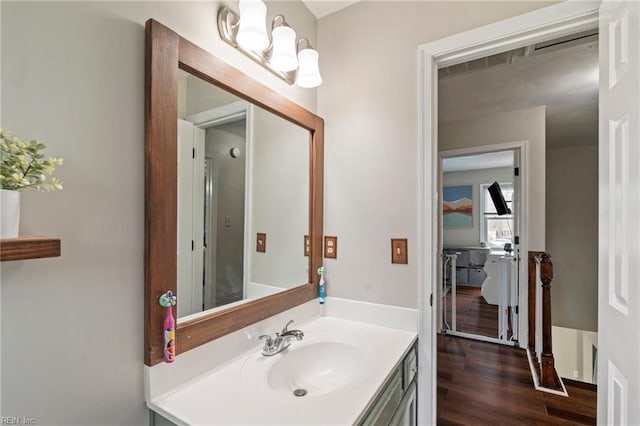 bathroom with hardwood / wood-style flooring and vanity