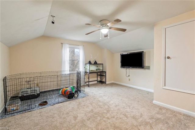 interior space with ceiling fan, light colored carpet, and lofted ceiling