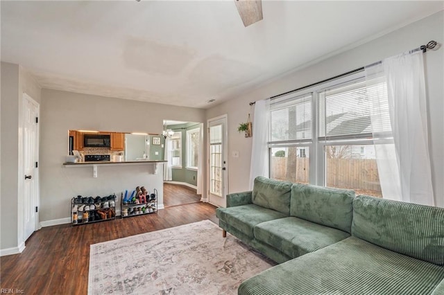 living room featuring dark hardwood / wood-style floors and a healthy amount of sunlight