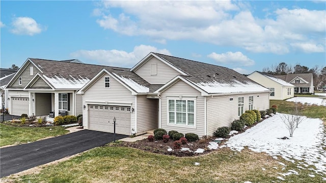 view of front of home with a garage and a front lawn