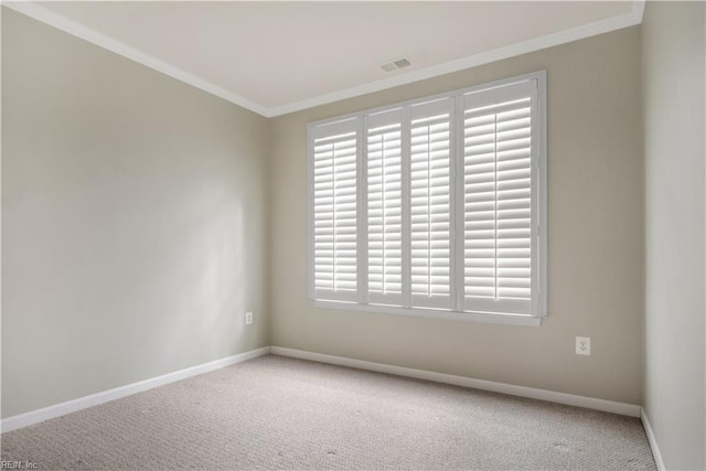 carpeted empty room featuring crown molding and plenty of natural light